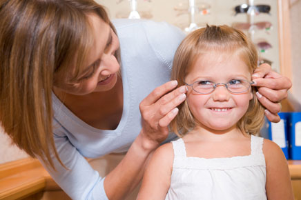 photo: young girl trying on frames