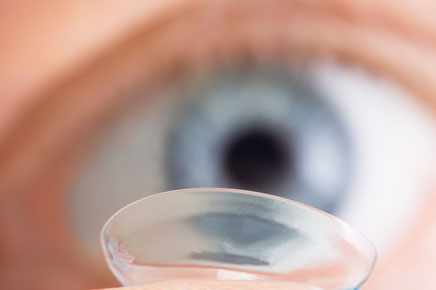 photo: inserting contact lens in eye
