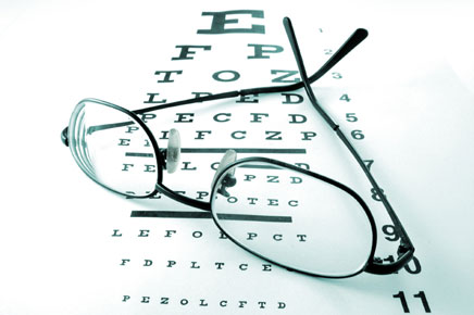 photo: glasses resting on eye chart