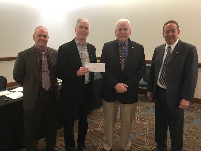 MCAO President Tim Farber thanks representatives from the Mechanical and Plumbing Industry Council Jim Primozic Tom Wanner and Keith Willkomm for their generous PAC contribution.