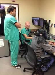 Christopher San Miguel, MD, EM PGY1; Andrew Gathof, MD, EM PGY3; and Monica Mikkilineni, MD, EM PGY1 working in the Critical Decision Unit