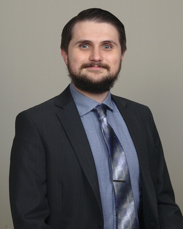 Adrian Gorzitze Maxey's Credentialing Headshot Suit With Gray Background