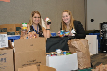 Student pharmacists Larecia Knoerzer and Brittany Schmidt count up the cans of food